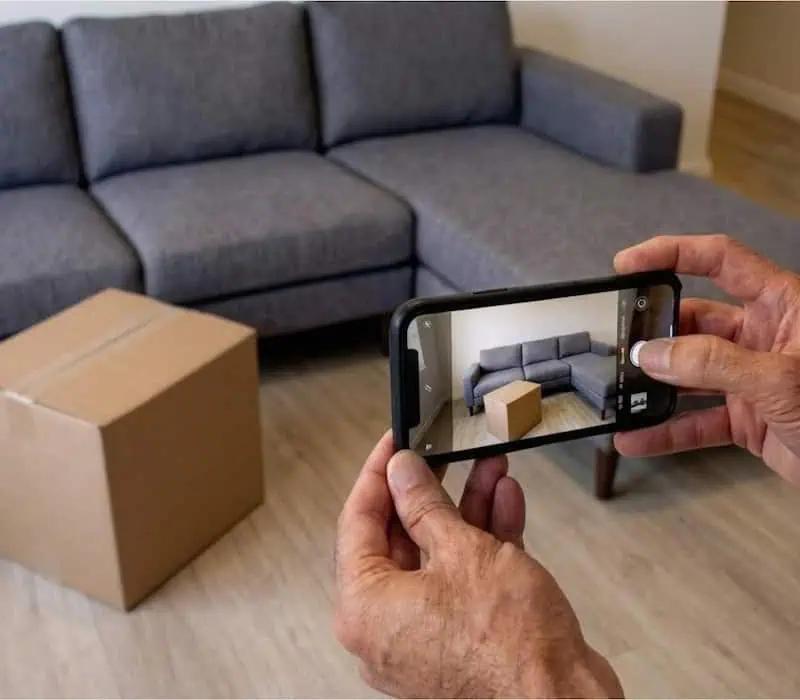 A photo showing someone taking a picture of their couch