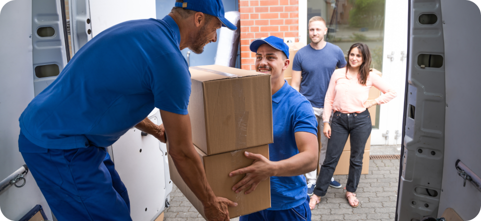 Two workers happily loading a moving truck