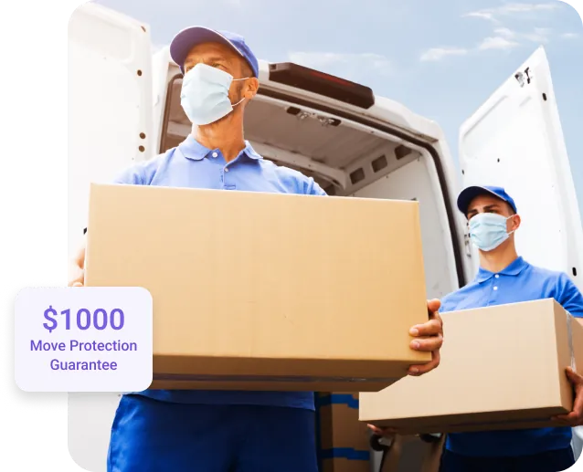 Two masked workers holding moving boxes 